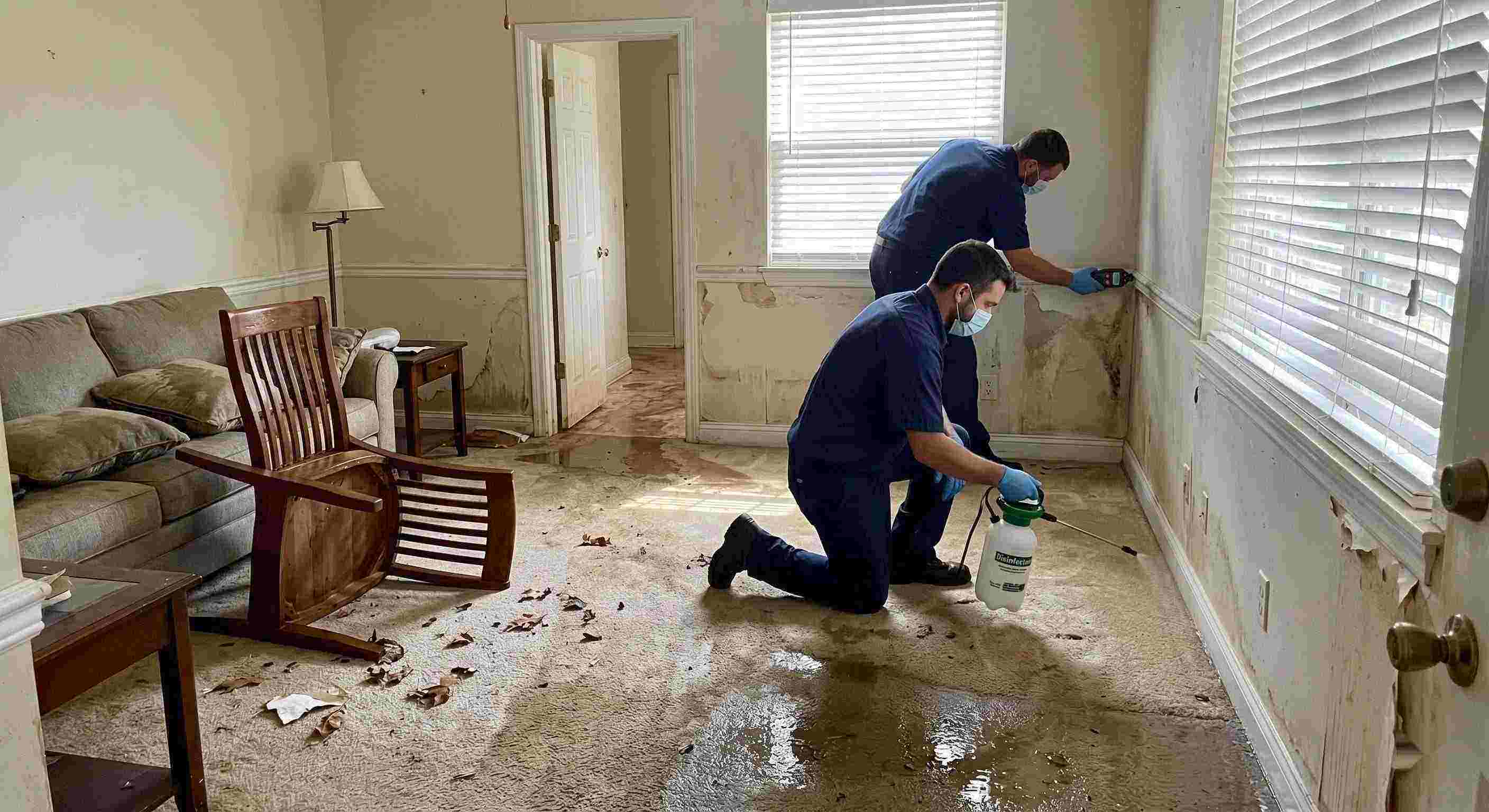 Fast technicians performing flood disinfection after water damage inside a home in Yuma, ensuring wet floors, damp walls, and household items are sanitized safely.